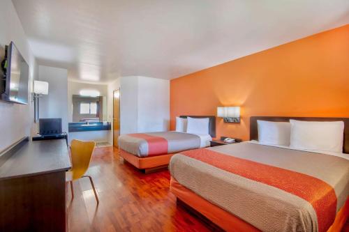 a hotel room with two beds and a desk at Motel 6-Santa Nella, CA - Los Banos in Santa Nella Village