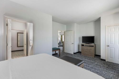 a room with a bed and a flat screen tv at Best Western Plus MidAmerica Hotel in Mascoutah