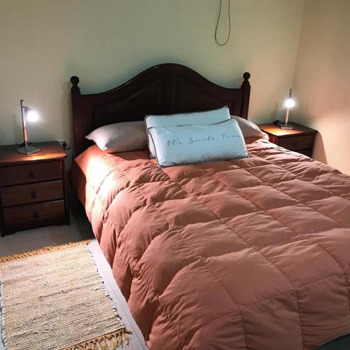 a bed with two pillows on it in a bedroom at Home J y M in Concordia