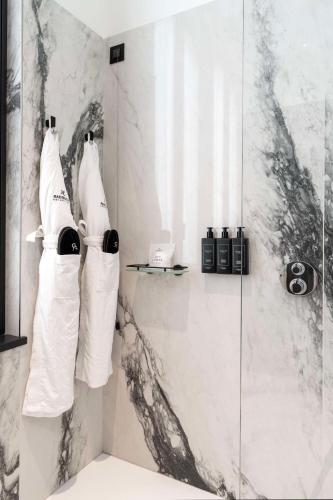 a bathroom with a shower with two white towels at Radisson Collection Hotel, Palazzo Touring Club Milan in Milan