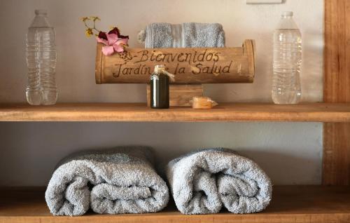 a shelf with towels and a bottle of soap at El jardín de la salud hotel in Fortín de las Flores