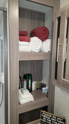 a towel rack with towels and towels in a bathroom at The River RV in Smithville