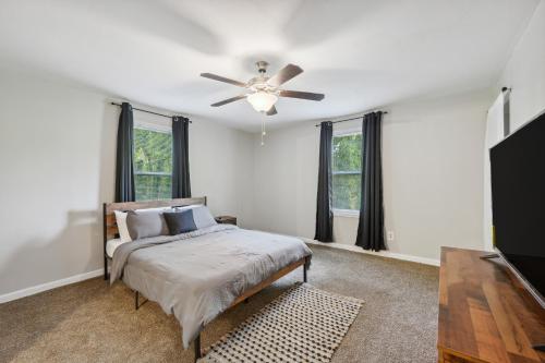a bedroom with a bed and a ceiling fan at Macon Cottage with Porch - 2 Mi to Downtown! in Macon