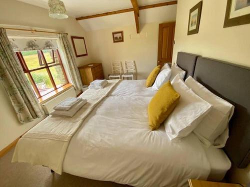 A bed or beds in a room at Trysor Holiday Cottage, Coach House with sea views