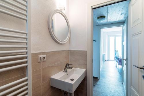 a bathroom with a sink and a mirror at Da Flora Wonderful Lakefront View in Colonno
