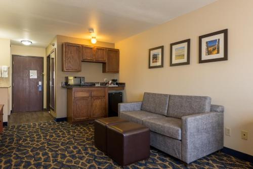 a living room with a couch and a kitchen at Comfort Inn & Suites Alamosa in Alamosa
