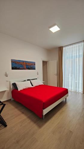 a bedroom with a large red bed in a room at B&B IMMARE in Brindisi
