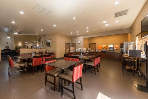 a dining room with tables and chairs in a restaurant at Comfort Inn & Suites Alamosa in Alamosa