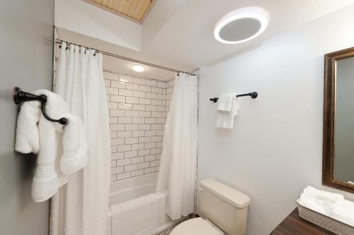 a bathroom with a white shower curtain and a toilet at Tamarron HighPoint 552 in Durango