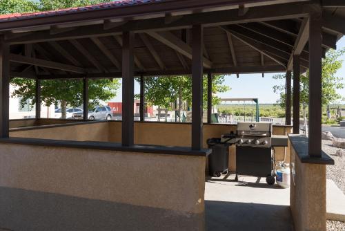 a pavilion with a grill in a parking lot at Comfort Inn & Suites Alamosa in Alamosa