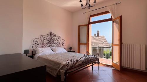 a bedroom with a bed and a large window at Casa Rosati - Baia Flaminia in Pesaro