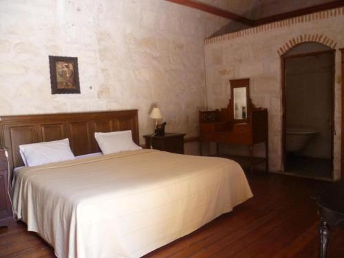 a bedroom with a large white bed and a desk at La Casa de Melgar in Arequipa