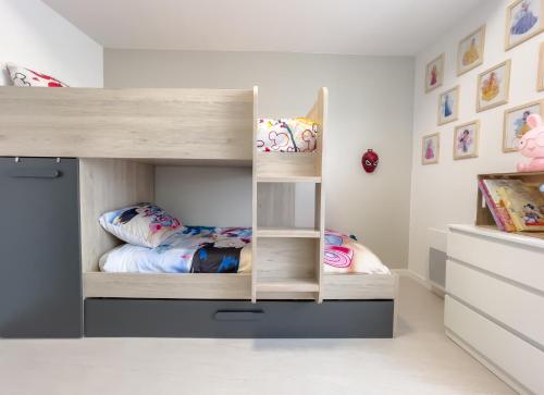 a childs bedroom with a bunk bed and a bunk bed at Duplex Disney in Coupvray