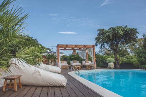 a swimming pool with a gazebo next to a swimming pool at Villa Pietra Estoril Eco Guesthouse in Estoril