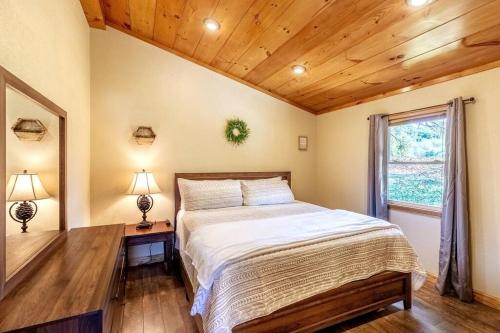 a bedroom with a bed and a window at *New Owner Special* Cozy Cabin with mountain views in Robbinsville