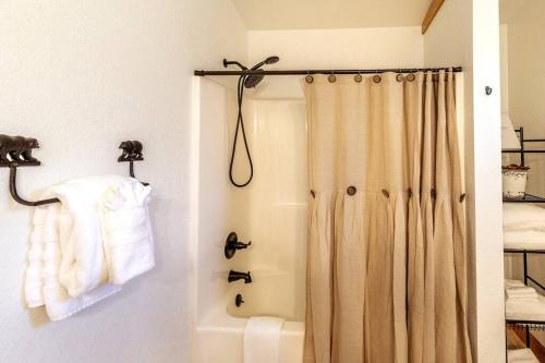 a bathroom with a shower with a shower curtain at *New Owner Special* Cozy Cabin with mountain views in Robbinsville
