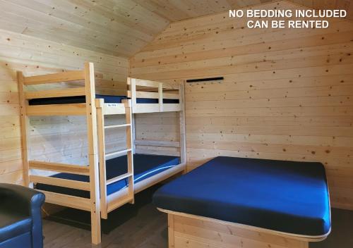 a cabin with two bunk beds and a ladder at Tobermory Village Cabins in Tobermory