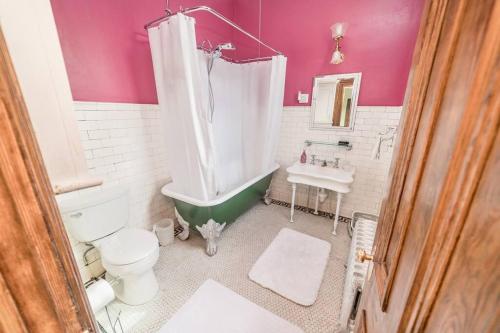 a bathroom with a tub and a toilet and a sink at Peaceful Easy Feelings - King Sized Bed - Sleeps 2 in Lynchburg