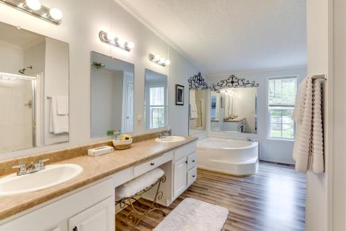 a bathroom with two sinks and a tub and a toilet at Lakefront Summerton Getaway with Boat Dock and Pool! in Summerton