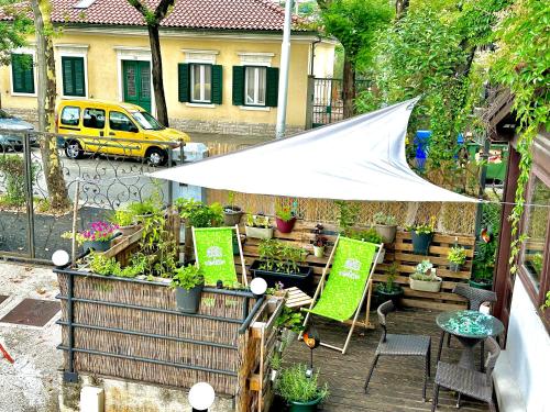 a garden with a white tent and some plants at Das Hostel Rijeka in Rijeka