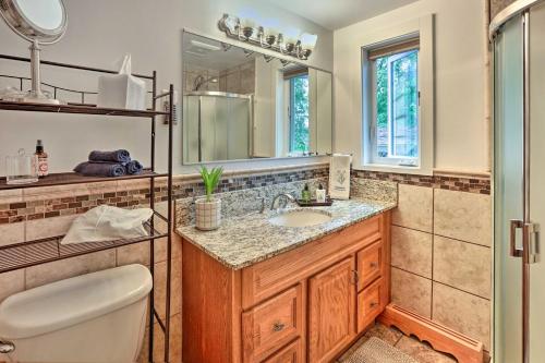 a bathroom with a sink and a toilet and a mirror at Northern Star - Main House in Fairbanks