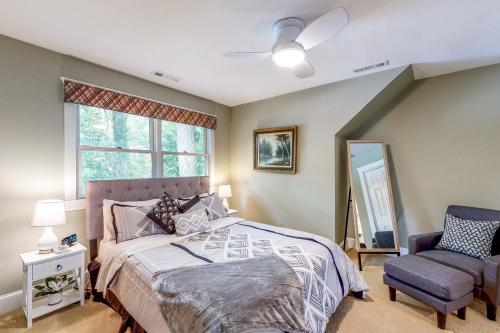 a bedroom with a bed and a chair and a window at Schumaker Pond Paradise in Salisbury