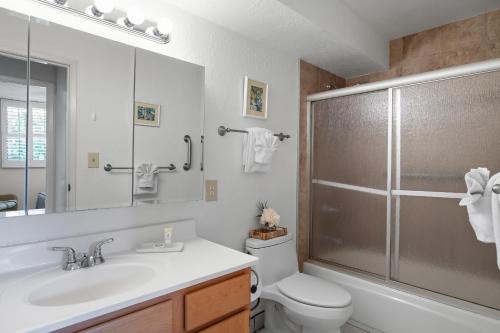a bathroom with a toilet and a sink and a shower at Kanai A Nalu 214 in Wailuku