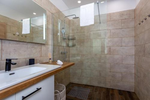 a bathroom with a sink and a shower at Villa Nela Apartments in Crikvenica
