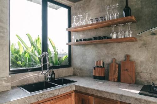 a kitchen counter with a sink and a window at Beach 600M - Designer Villas - Perenenean - Private Pool in Canggu