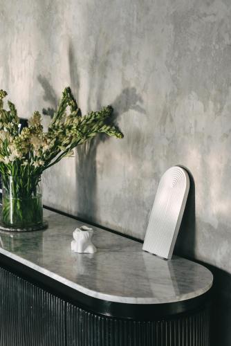 a table with a vase and a plant on it at Beach 600M - Designer Villas - Perenenean - Private Pool in Canggu