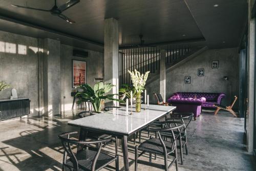 a dining room with a table and chairs at Beach 600M - Designer Villas - Perenenean - Private Pool in Canggu