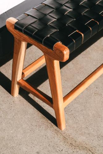 a wooden stool with a black leather seat at Beach 600M - Designer Villas - Perenenean - Private Pool in Canggu