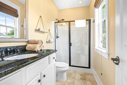 a bathroom with a toilet and a sink and a shower at Barefoot Livin' in Myrtle Beach