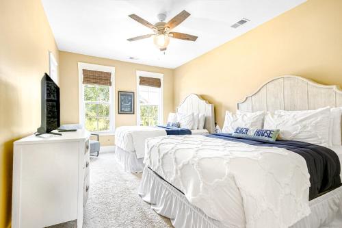 a bedroom with two beds and a ceiling fan at Barefoot Livin' in Myrtle Beach