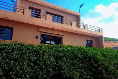 a house with a hedge in front of it at Lake House Boulaouane in El Jadida