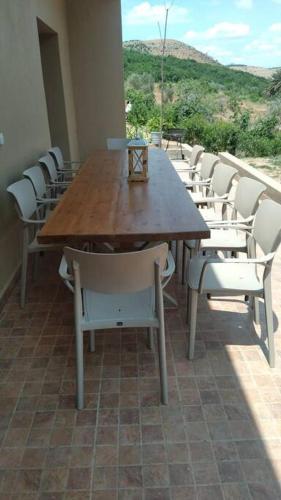 a wooden table and chairs in a room at Lake House Boulaouane in El Jadida