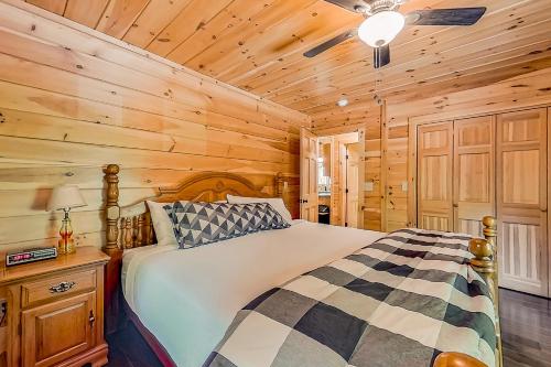 a bedroom with a bed in a wooden cabin at Secluded Haven - Entire House in Wevertown