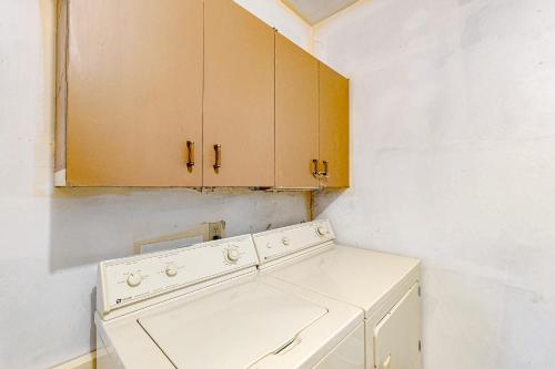 a kitchen with a white stove and cabinets at Garden Hideaway in Wiscasset
