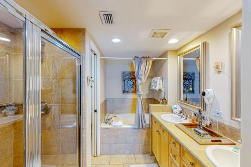 a bathroom with two sinks and a shower at Portofino Island Resort and Spa Tower 1 608 in Pensacola Beach