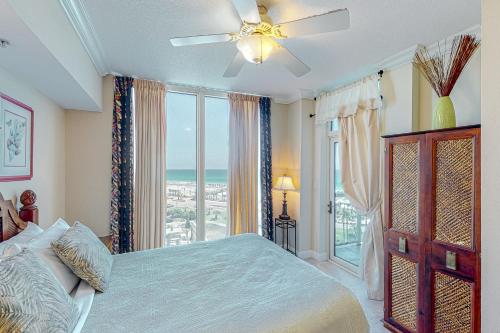 a bedroom with a bed and a large window at Portofino Island Resort and Spa Tower 1 608 in Pensacola Beach