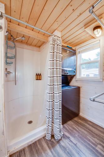 a bathroom in a tiny house with a shower at Taos Motor Lodge in Taos
