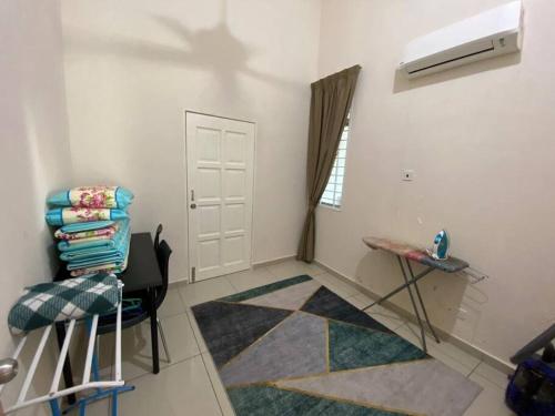 a room with a white door and a table and a window at jm homestay semi d premium in Shah Alam