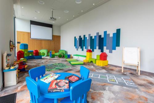 a classroom with a table and chairs and a chalkboard at Holiday Inn Gdansk - City Centre by IHG in Gdańsk