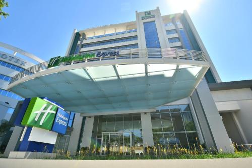 a large building with a round walkway in front of it at Holiday Inn Express Asuncion Aviadores by IHG in Asuncion
