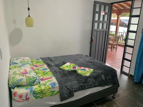 a bedroom with a bed with two bags on it at Balcones de la Casona in Guatapé
