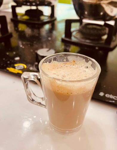 a cup of coffee sitting on top of a counter at Vasthyam in Kenichira