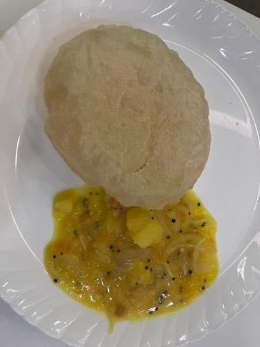a plate of food with a roll and a ball of bread at Vasthyam in Kenichira