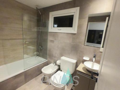 a bathroom with a toilet and a sink and a shower at Departamento Entre Pinos in San Carlos de Bariloche