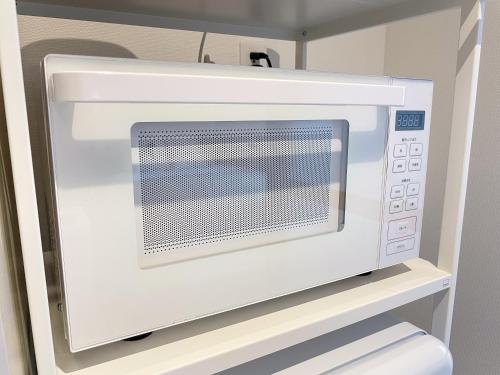 a microwave oven sitting on top of a shelf at amp urbanstay akasaka in Susakiuramachi