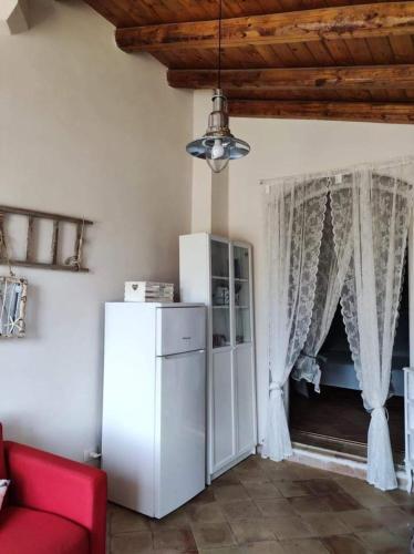 sala de estar con nevera blanca y sofá rojo en Casa Francesca Romana, en Marina di Noto